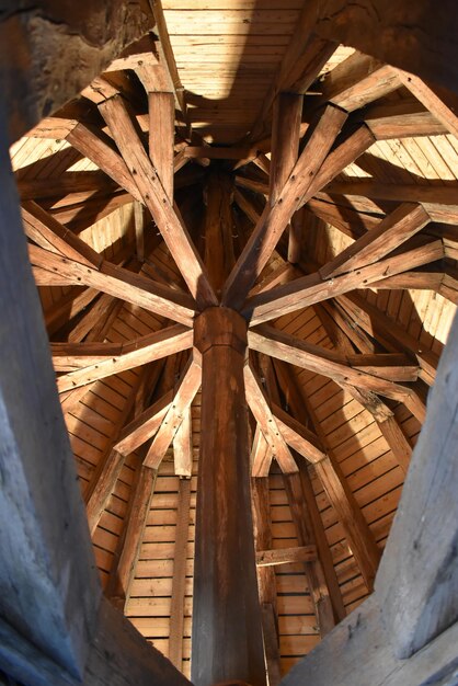 A close-up shot of the intricate wooden beams and construction details inside a covered bridge, showcasing the craftsmanship and engineering of the structure.