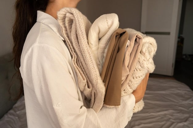 A close-up shot showcasing a capsule wardrobe laid out on a bed, including neutral-colored shirts, pants, skirts, a dress, and a jacket, demonstrating versatility.