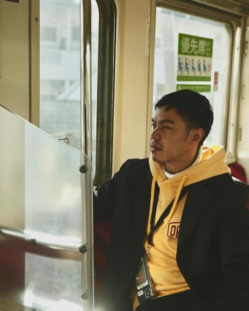 A photo of a traveler using a city bus in Kyoto, Japan. The bus is clean and efficient, and the traveler looks comfortable and content. The image should emphasize the ease and affordability of using public transportation.