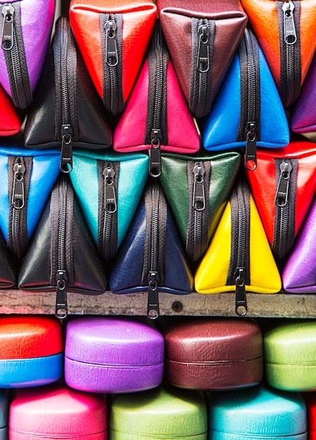 Close-up of different colored packing cubes neatly stacked inside a travel backpack, showcasing various sizes and how they fit together efficiently, maximizing the backpack's capacity.