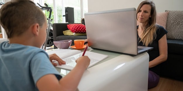 A student practices speaking Spanish with a tutor online. The tutor is providing encouragement and guidance. The setting is a bright and comfortable home office.