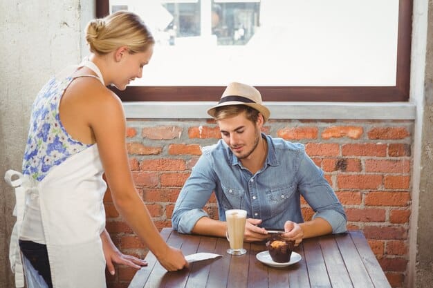 A solo traveler sitting at a local café, enjoying a cup of coffee and engaging in a conversation with a local resident.