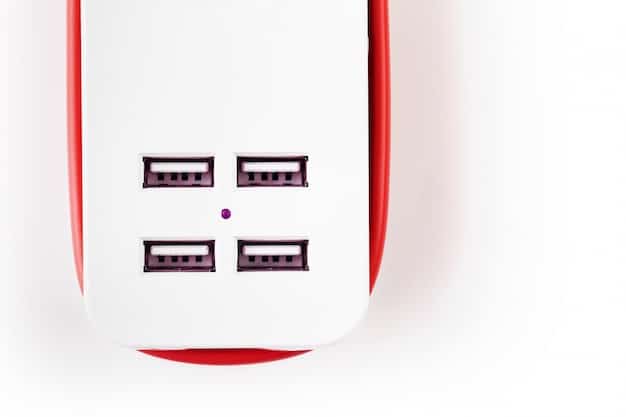 Close-up shot of a universal travel adapter plugged into a foreign wall socket, charging multiple devices such as a smartphone, tablet, and camera displaying their charging indicators; set against a background of a hotel room nightstand.