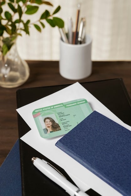 Close-up of various forms of identification, including a US driver's license, a birth certificate, and a photocopy of a US passport, arranged neatly on a table.