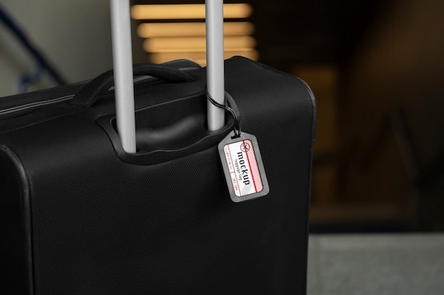 A close-up of an airline baggage tag attached to a black suitcase, with airport conveyor belts blurred in the background.