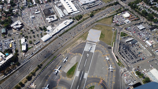 An aerial or wide-angle shot of a busy airport terminal with various pathways leading to different gates, showing a harmonious flow of passengers. There are clear signs directing travelers, and the emphasis is on efficiency and organization.