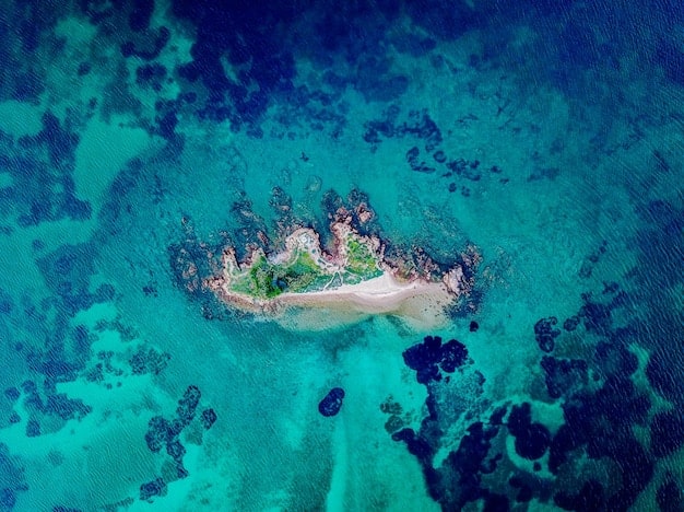 An aerial view of Dry Tortugas National Park, showing Fort Jefferson on a small island surrounded by stunning turquoise waters and vibrant coral reefs.