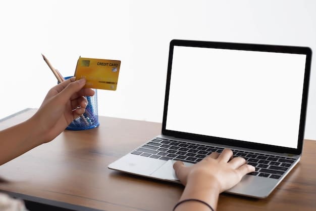 A hand holding a credit card near a laptop showing an online payment gateway with various payment options and a small text indicating