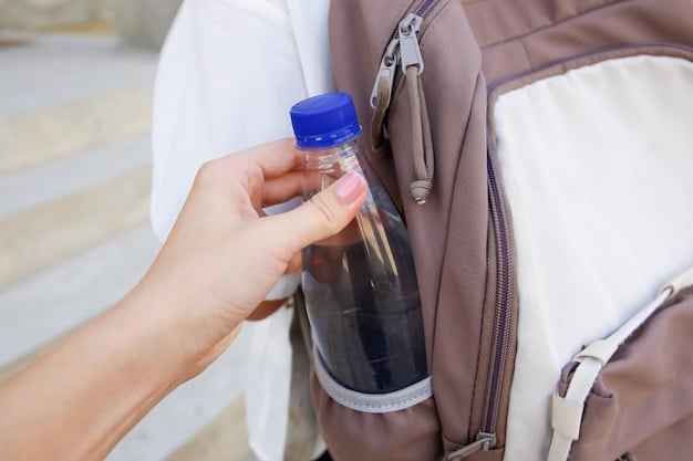 A person holding a reusable water bottle and a small bag of snacks, boarding an airplane, symbolizing preparation to avoid in-flight fees.